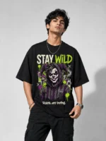 Stay Wild oversized black printed joker graphic t-shirt for men with neon green graffiti design Rules Are Boring - streetwear fashion - Voux.in