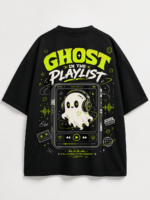 Young woman wearing VOUX black oversized cotton t-shirt with neon green Ghost in the Playlist graphic print on the back, featuring a cute ghost with headphones on a retro music player, styled in streetwear aesthetic against a city sunset backdrop
