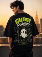 Young woman wearing VOUX black oversized cotton t-shirt with neon green Ghost in the Playlist graphic print on the back, featuring a cute ghost with headphones on a retro music player, styled in streetwear aesthetic against a city sunset backdrop